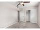 Bedroom with a closet, carpet, ceiling fan, and a view to another room at 9803 N 40Th Dr, Phoenix, AZ 85051