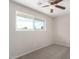 Bright bedroom with ceiling fan, neutral carpet, and a window at 9803 N 40Th Dr, Phoenix, AZ 85051