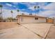 Single-story house featuring a spacious driveway and desert landscaping at 9803 N 40Th Dr, Phoenix, AZ 85051