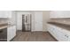 Updated kitchen with stainless steel fridge, white cabinetry, and modern finishes at 9803 N 40Th Dr, Phoenix, AZ 85051