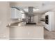 Modern kitchen with stainless steel appliances, white cabinets, and a breakfast bar at 9803 N 40Th Dr, Phoenix, AZ 85051