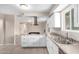 Bright kitchen features white cabinetry, stainless appliances, and an island gas cooktop at 9803 N 40Th Dr, Phoenix, AZ 85051