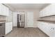 Bright kitchen featuring stainless steel refrigerator, white cabinets, and neutral countertops at 9803 N 40Th Dr, Phoenix, AZ 85051