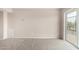 Large living room featuring carpet and a patio door for outdoor access at 9803 N 40Th Dr, Phoenix, AZ 85051