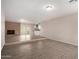 Bright living room showcasing modern floors, brick fireplace, and convenient access to the kitchen at 9803 N 40Th Dr, Phoenix, AZ 85051