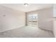 Open living room with carpet flooring and access to a balcony or patio at 9803 N 40Th Dr, Phoenix, AZ 85051