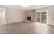 Bright living room features a brick fireplace, wood-look flooring, and natural light from the sliding glass doors at 9803 N 40Th Dr, Phoenix, AZ 85051