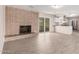 Open-concept living room with brick fireplace seamlessly connects to the modern kitchen with a breakfast bar at 9803 N 40Th Dr, Phoenix, AZ 85051