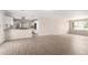Bright living room opens to modern kitchen with stainless appliances and ample countertop space for cooking at 9803 N 40Th Dr, Phoenix, AZ 85051