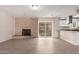 Relaxing living room featuring a brick fireplace, sliding doors, and easy access to the kitchen at 9803 N 40Th Dr, Phoenix, AZ 85051