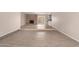 Spacious living room featuring tile floors, a cozy brick fireplace, and sliding door access to the backyard at 9803 N 40Th Dr, Phoenix, AZ 85051