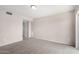 Spacious living room with neutral carpet, a ceiling light, and a doorway at 9803 N 40Th Dr, Phoenix, AZ 85051