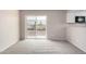 Bright living room featuring a sliding glass door and plush carpeting at 9803 N 40Th Dr, Phoenix, AZ 85051