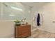 Bright bathroom featuring a glass-enclosed shower, a modern vanity, and stylish tile flooring at 10447 W Salter Dr, Peoria, AZ 85382
