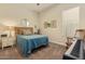 Cozy bedroom with a comfortable bed, natural light, and a stylish nightstand and home decor at 10447 W Salter Dr, Peoria, AZ 85382