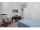 A serene bedroom featuring a piano, rocking chair, a painting, and soft natural light at 10447 W Salter Dr, Peoria, AZ 85382