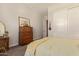 Relaxing bedroom with a classic dresser, a decorative mirror, and soft lighting at 10447 W Salter Dr, Peoria, AZ 85382