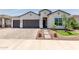 Charming home featuring a three-car garage, landscaped yard, and inviting walkway at 10447 W Salter Dr, Peoria, AZ 85382