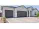 Three-car garage and large driveway, providing ample parking space at 10447 W Salter Dr, Peoria, AZ 85382