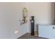 Functional garage corner with water heater, water softener, and freezer for added convenience at 10447 W Salter Dr, Peoria, AZ 85382