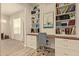 Well-lit home office with custom built-in bookshelves, a spacious desk, and modern decor at 10447 W Salter Dr, Peoria, AZ 85382