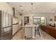 Modern kitchen with stainless steel appliances, a large island, pendant lighting, and an open floor plan at 10447 W Salter Dr, Peoria, AZ 85382
