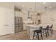 Bright, eat-in kitchen featuring stainless steel appliances, white cabinetry, and a stylish central island at 10447 W Salter Dr, Peoria, AZ 85382