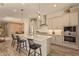 Spacious eat-in kitchen with white cabinetry, stainless steel appliances, a central island, and modern pendant lighting at 10447 W Salter Dr, Peoria, AZ 85382