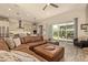 Open-concept living room and kitchen with sliding glass doors leading to the outdoor space at 10447 W Salter Dr, Peoria, AZ 85382