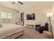 Serene main bedroom with neutral tones, a ceiling fan, plush carpeting, and ample natural light at 10447 W Salter Dr, Peoria, AZ 85382
