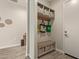 Well-organized mud room with bench seating, storage baskets, hooks and a door to the exterior at 10447 W Salter Dr, Peoria, AZ 85382