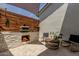 Outdoor kitchen and sitting area with a pizza oven and a privacy fence at 10447 W Salter Dr, Peoria, AZ 85382