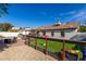 Backyard featuring a pool, paver patio, dog run, and green grass for outdoor enjoyment at 13918 N 78Th Ave, Peoria, AZ 85381