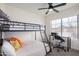 Bright bedroom with a modern bunk bed, ceiling fan, desk, and window at 13918 N 78Th Ave, Peoria, AZ 85381