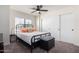 Bedroom with a window and sliding door closet; decorated with a modern bed and black accents at 13918 N 78Th Ave, Peoria, AZ 85381