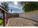 Fenced dog run is surfaced with gravel and has gated access to the yard at 13918 N 78Th Ave, Peoria, AZ 85381