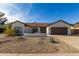 Charming single-story home featuring a xeriscaped front yard and an attached two-car garage at 13918 N 78Th Ave, Peoria, AZ 85381
