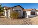 Charming single-story home featuring a xeriscaped front yard with a two-car garage, palm trees, and desert plants at 13918 N 78Th Ave, Peoria, AZ 85381