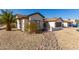 Charming single-story home featuring a xeriscaped front yard with a two-car garage, palm trees, and desert plants at 13918 N 78Th Ave, Peoria, AZ 85381