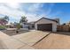 Single-story home with a brown roof, xeriscaped yard and a two-car attached garage with a concrete driveway at 13918 N 78Th Ave, Peoria, AZ 85381