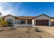 Charming single-story home featuring a xeriscaped front yard and an attached two-car garage at 13918 N 78Th Ave, Peoria, AZ 85381
