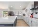Bright, modern kitchen with stainless steel appliances, custom cabinets, and a large island for meal preparation at 13918 N 78Th Ave, Peoria, AZ 85381