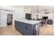 Open concept kitchen island with seating, stainless appliances, and a barn door pantry at 13918 N 78Th Ave, Peoria, AZ 85381
