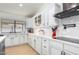 Updated kitchen features white cabinetry, quartz countertops, and stainless steel appliances at 13918 N 78Th Ave, Peoria, AZ 85381
