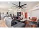 Bright living room featuring vaulted ceiling, hardwood floors, and a view into the adjacent kitchen at 13918 N 78Th Ave, Peoria, AZ 85381