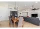Open floorplan with dining area leading to a living room with modern furnishings, light-colored wood floors and lots of light at 13918 N 78Th Ave, Peoria, AZ 85381