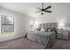 Well-lit main bedroom features carpeted floors, ceiling fan, and an ensuite at 13918 N 78Th Ave, Peoria, AZ 85381