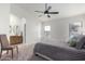 Bright main bedroom features a ceiling fan, ensuite bath, and large window at 13918 N 78Th Ave, Peoria, AZ 85381