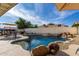 Backyard pool features a waterfall, desert landscaping and plenty of lounge seating for enjoying outdoor living at 13918 N 78Th Ave, Peoria, AZ 85381