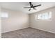 Bright bedroom with neutral walls, carpet flooring, and a ceiling fan at 143 W Ray Rd, Chandler, AZ 85225